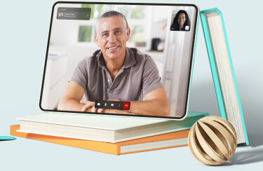 A tablet showing an active telemedicine session standing on a pile of books