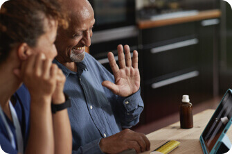 Elderly couple smiling during a telemedicine session with their provider